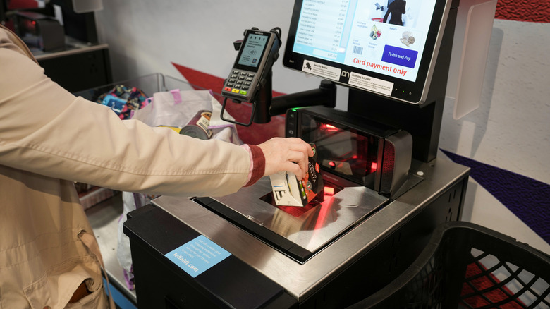 Customer using Aldi's self-checkout