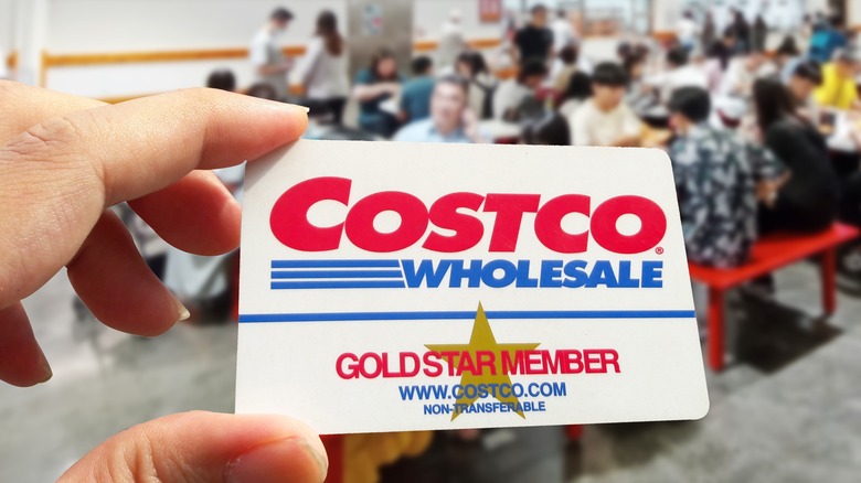 Person holding Costco membership card