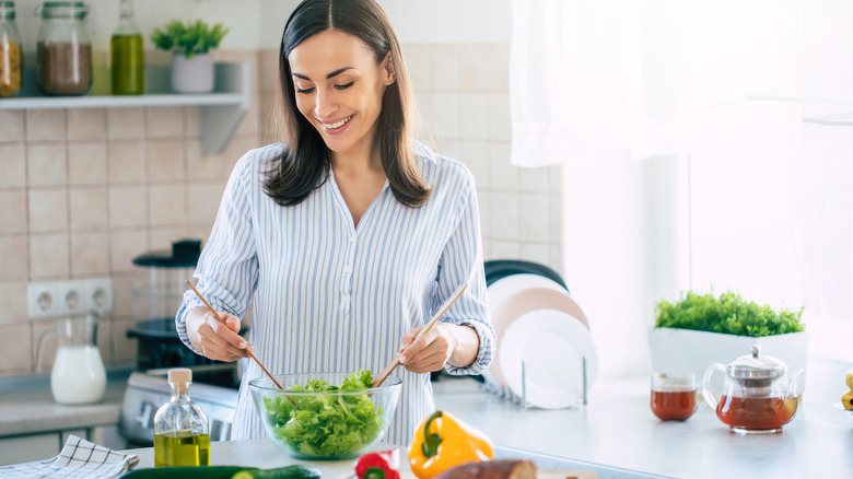 woman making a salad at home