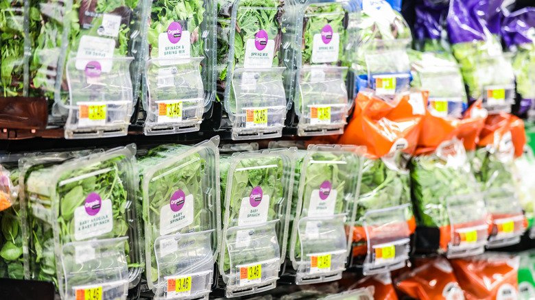 containers and bags of spinach at Walmart