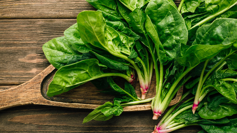 spinach leaves on a wood surface