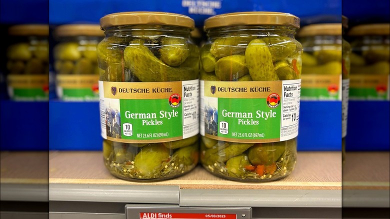 Two jars of pickles on a shelf