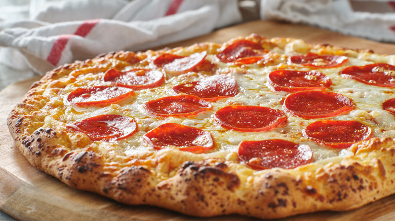 Pepperoni pizza on a cutting board