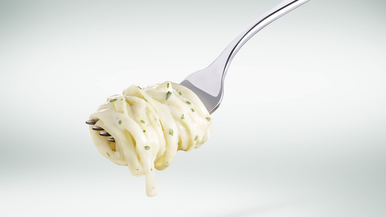 Fork with alfredo noodles twirled on it