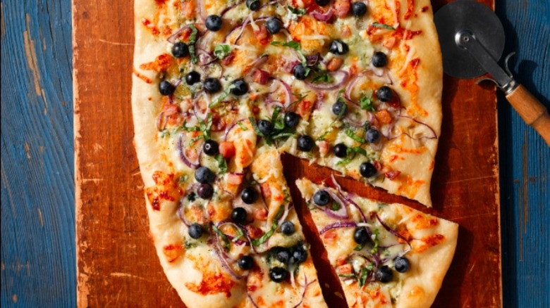 savory blueberry pizza on board