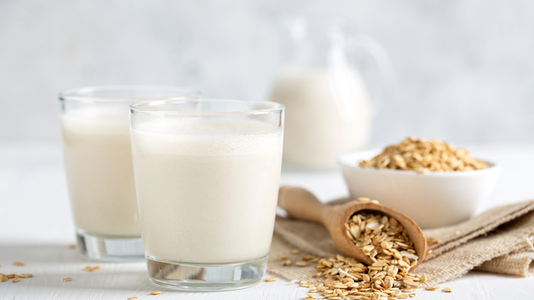 homemade oat milk in glasses on counter