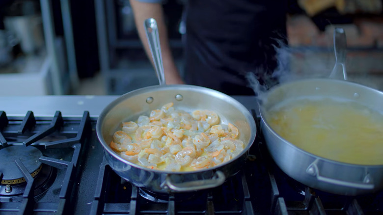 Sauteing shrimp in a pan