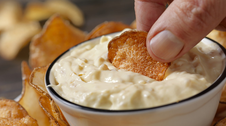 french onion dip in bowl with chip