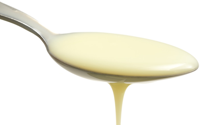 Sweetened condensed milk on spoon