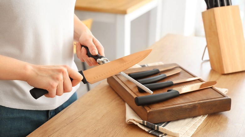 Person sharpening a knife