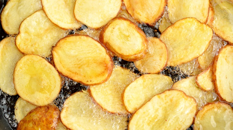 Potato chips cooking in oil