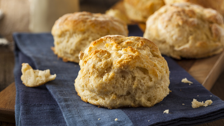 Fluffy biscuits on blue cloth