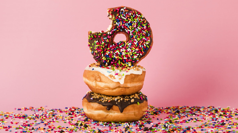 stack of three donuts with sprinkles