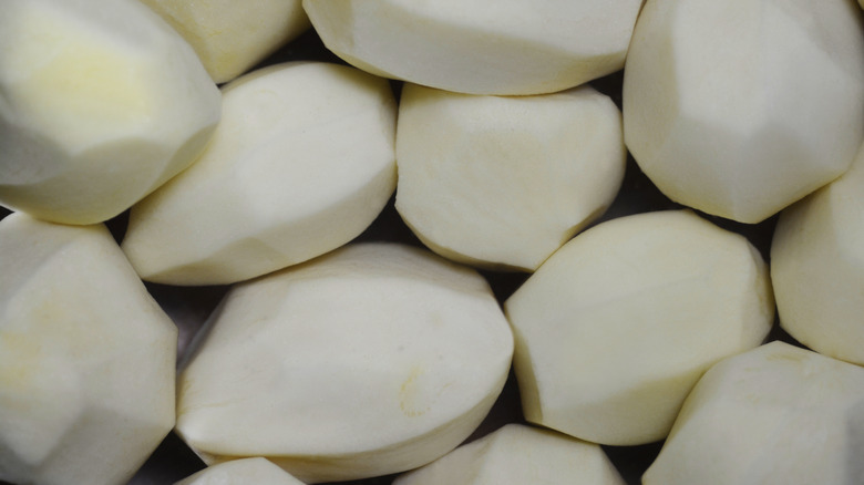 Peeled potatoes soaking in water