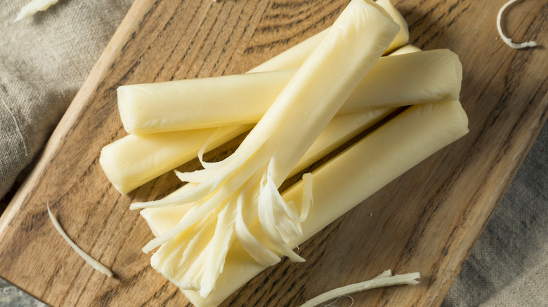 String cheese pile on cutting board