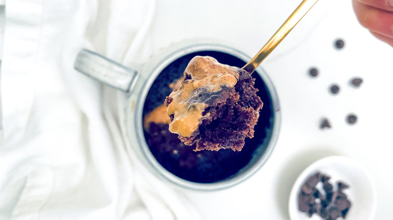 spoonful over mug almond butter brownie