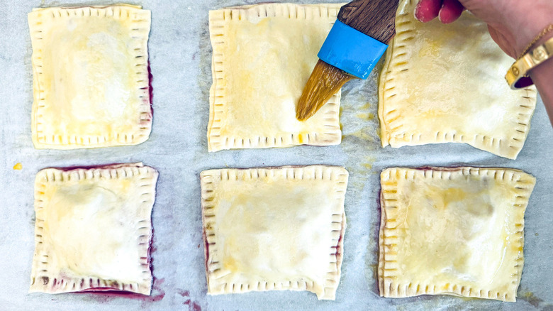 egg wash brushing onto pastry squares