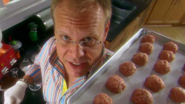 Alton Brown holding meatball tray