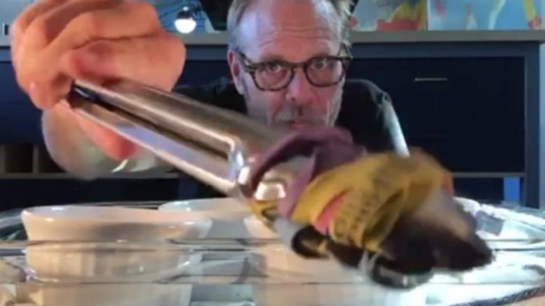 Alton Brown with banded tongs