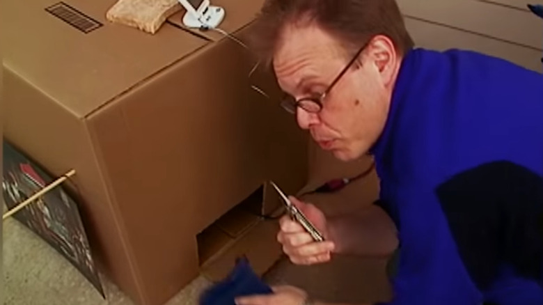 Alton Brown using his cardboard box smoker on an episode of Good Eats