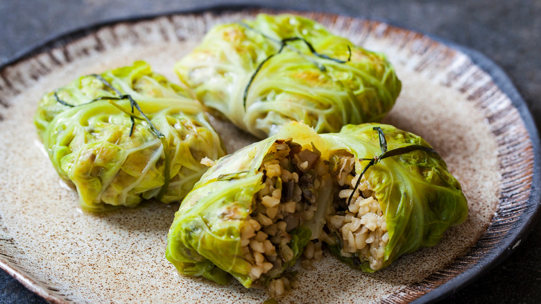 cabbage parcels tied with chives on plate