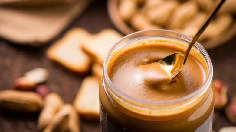 A spoon in a peanut butter jar