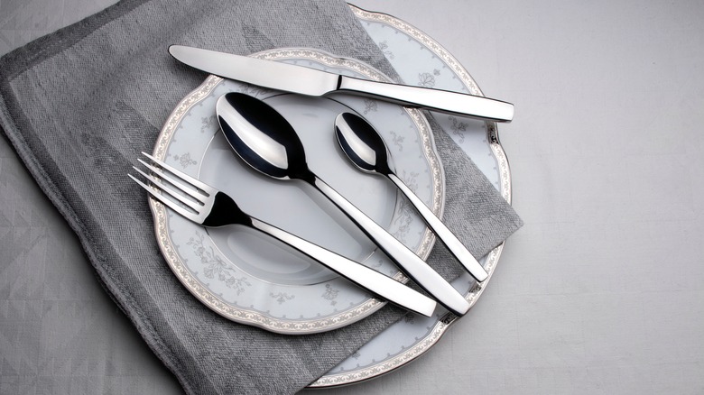 Silverware on plate and linen
