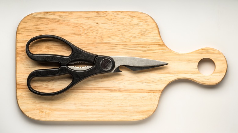 Kitchen scissors on cutting board