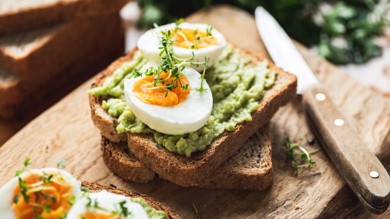 https://www.thedailymeal.com/img/gallery/amp-up-avocado-toast-with-hard-boiled-eggs-and-a-grater/intro-1688738368.jpg