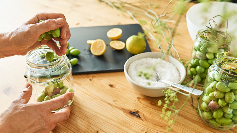 Person pickling olives with MSG 