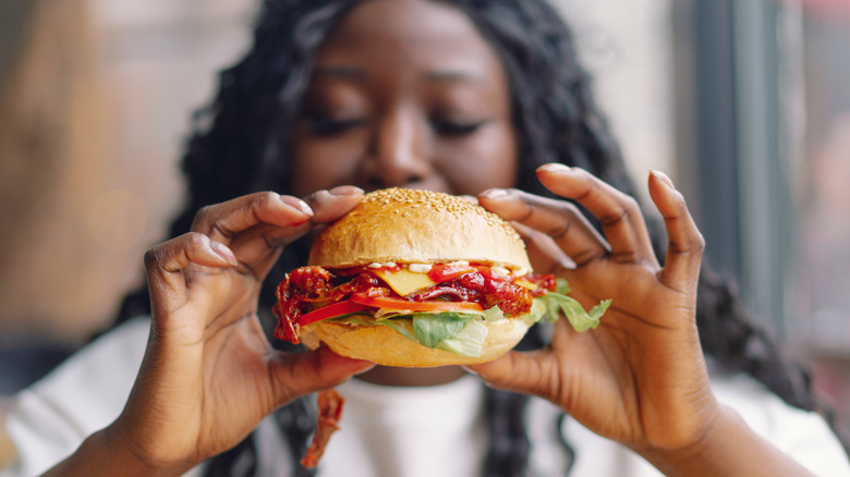 A man really enjoying a burger