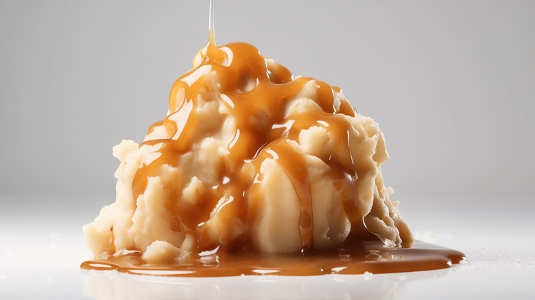 Gravy drizzling on mashed potatoes