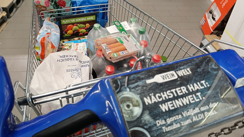 An Aldi shopping cart is filled with food and drink.