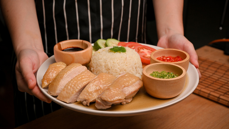 Hainanese-style chicken being served