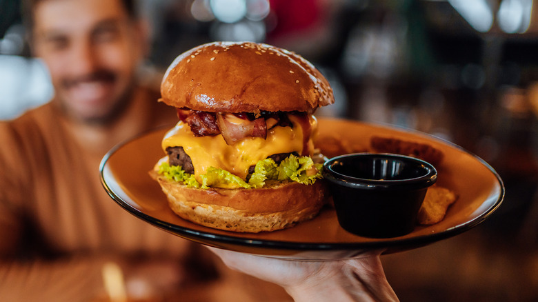 plate held up with cheeseburger