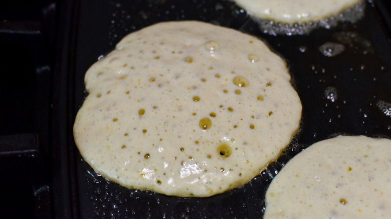 half-cooked pancakes in pan