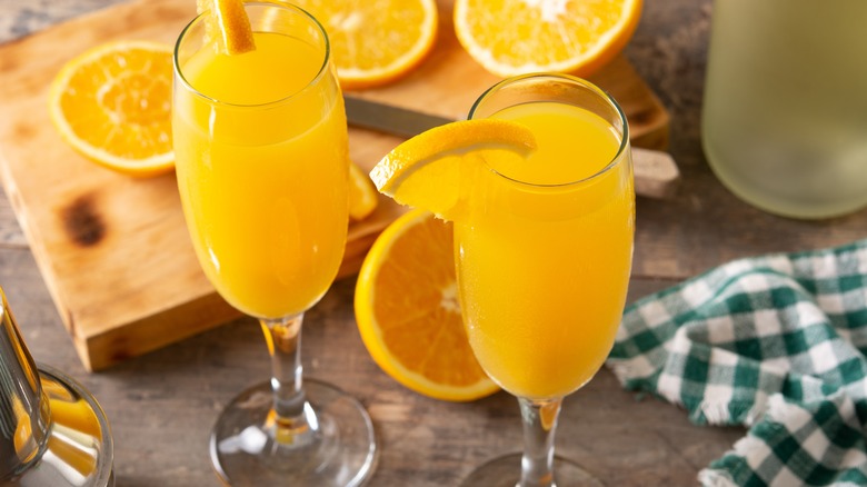 Mimosas with cutting board and orange slices