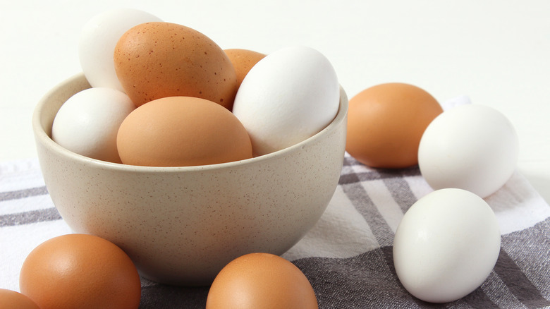 brown and white eggs in bowl 