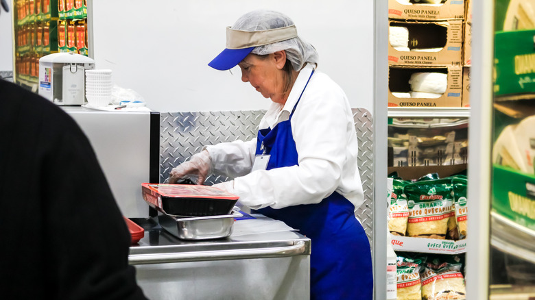 A person preparing Costco samples