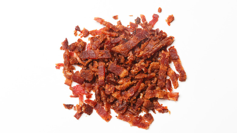 a pile of bacon bits on white background