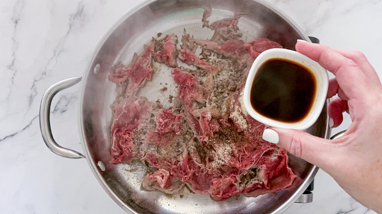 beef cooking in skillet 