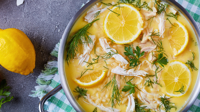 Avgolemono sauce with chicken and lemons in a pan