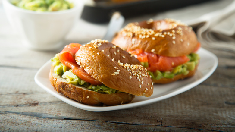 Guacamole and meat on a sesame seed bagel