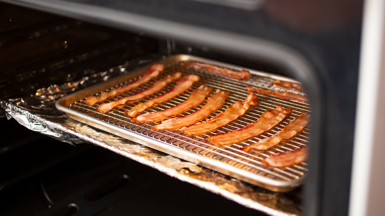 Bacon in oven cooking on cooling rack