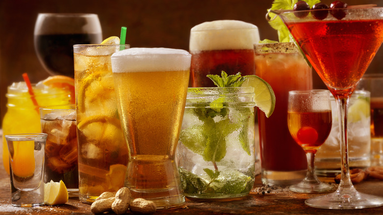 A variety of beer and cocktails sitting on a table