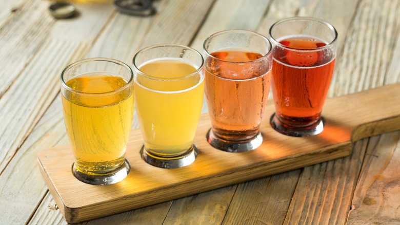 Flight of hard ciders on a wooden surface