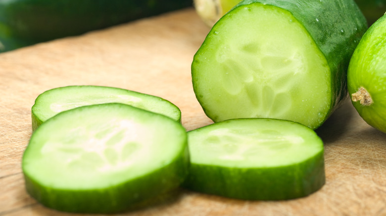 Sliced cucumber on cutting board