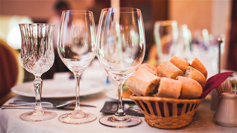 Empty wine glasses and bread basket 