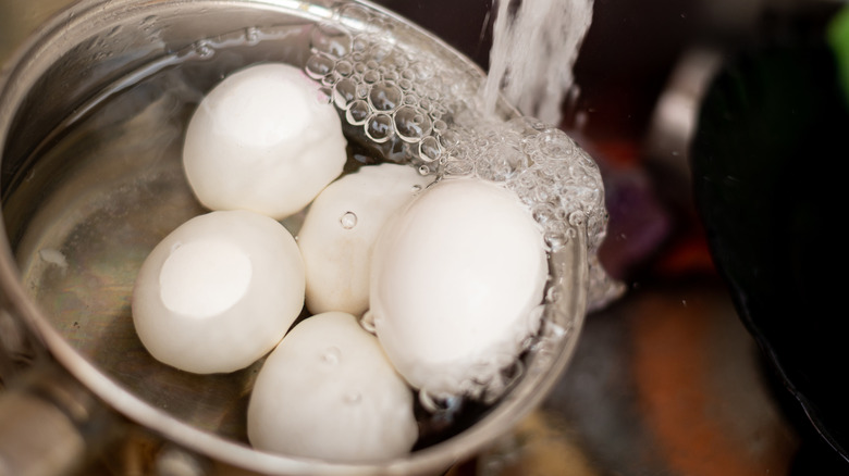 pot of eggs under running water