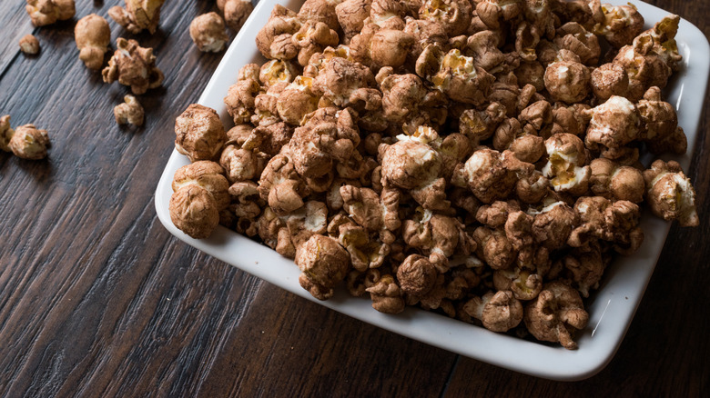 A bowl of popcorn coated in chocolate